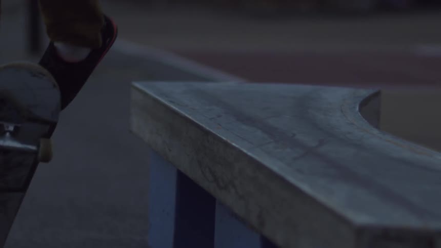 A skateboarder jumps onto a concrete ledge
