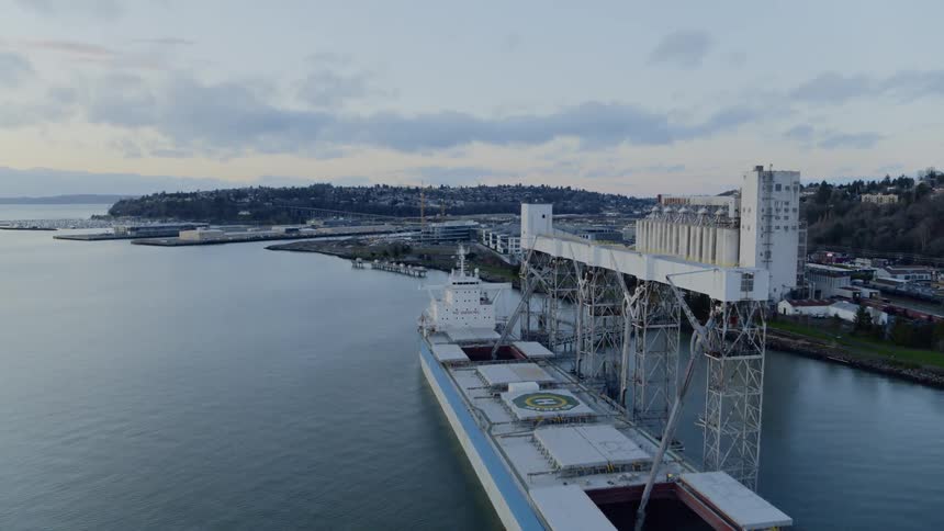 Flying over a grain cargo ship being loaded at port