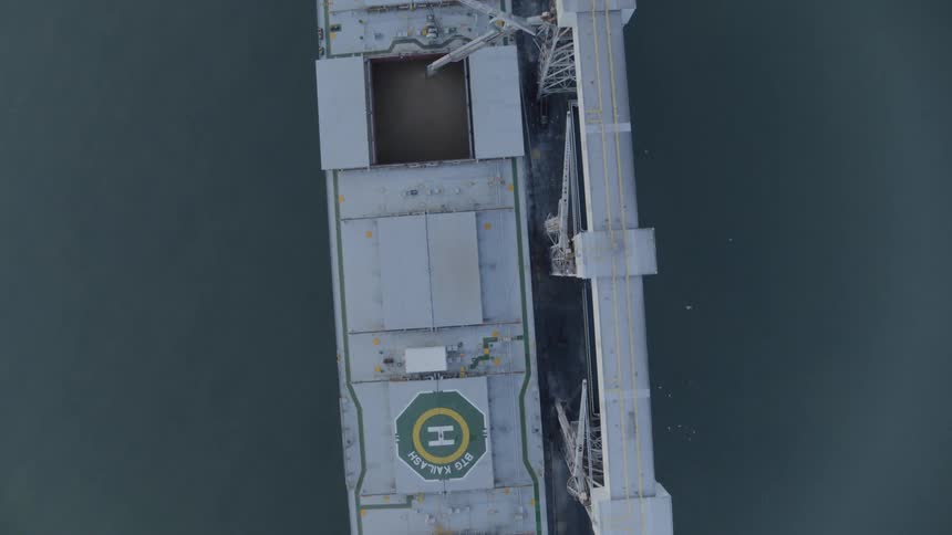 Birds eye traverse of grain being loaded into the holds of a cargo ship