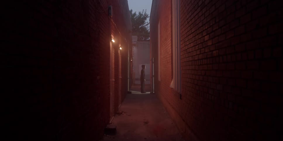 A man walks into a door in a dark alley