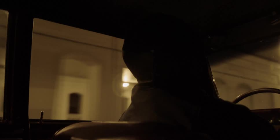 A person drives at night