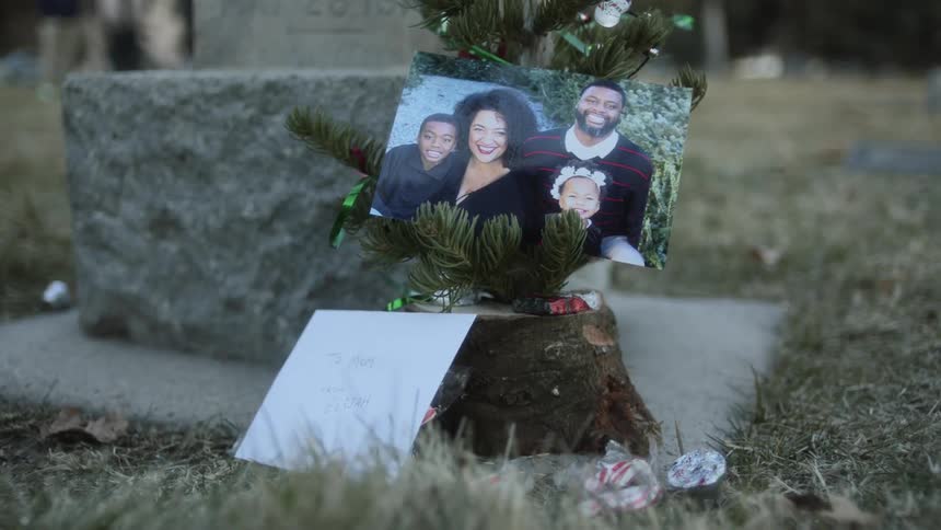 Picture of a family place on small christmas tree near a grave