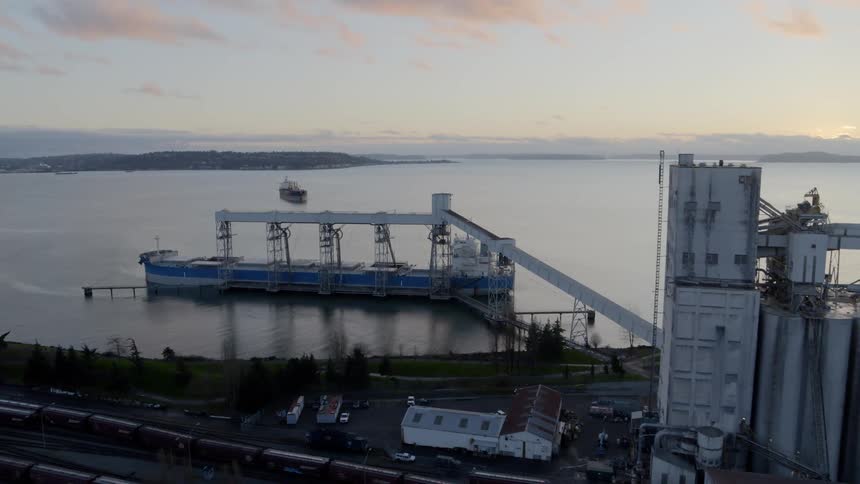 Slow orbit around a seaport grain shipping terminal at sunset