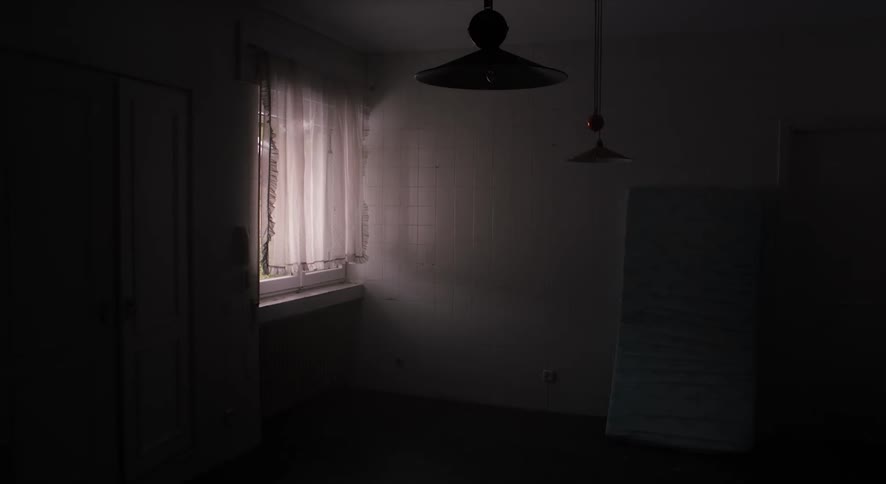 A man is in his house and opening a window
