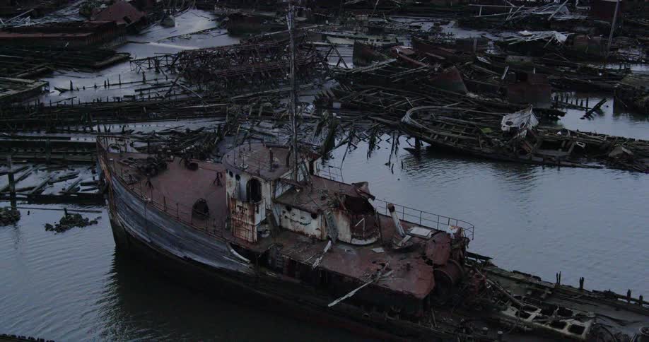 An aerial view of an abandoned whip in a shipyard