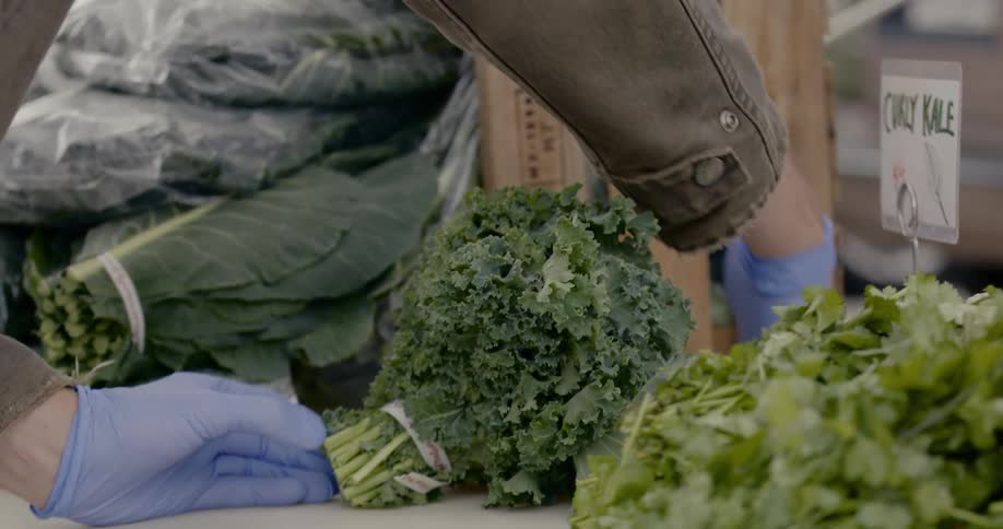 A person sets up a produce stand
