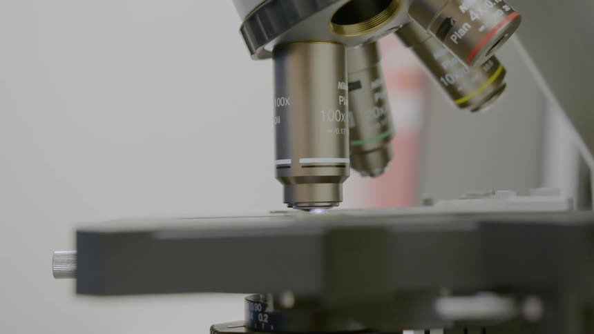 A microscope with the closest zoom pointed at a slide