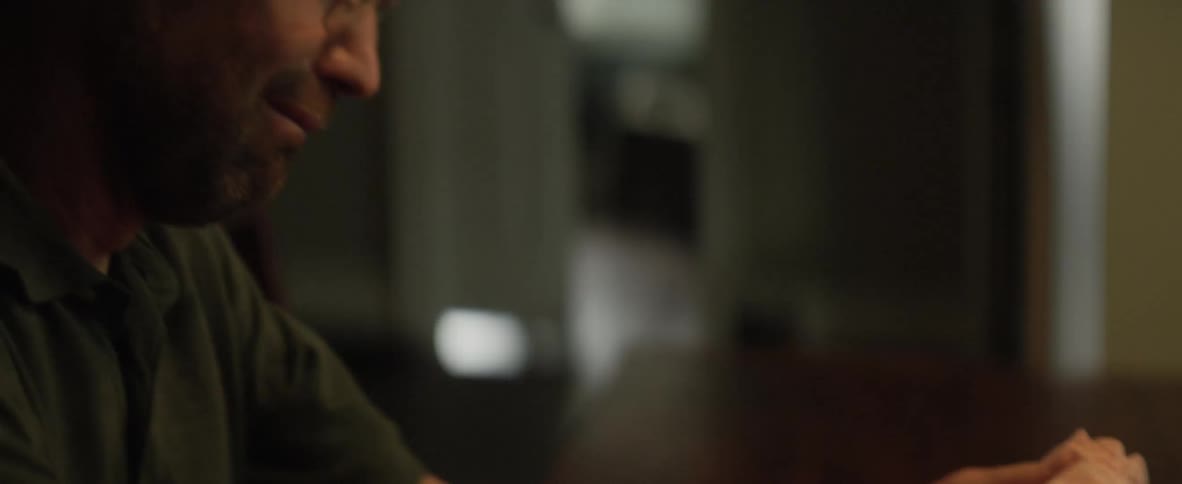 A man cries while holding a blanket that reads daddys little girl