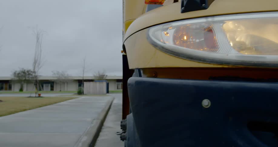 A school bus is parked at a school