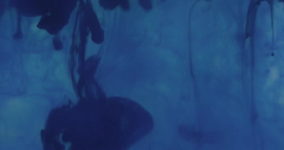 Blue blobs liquid slowly descend and spread in another blue liquid