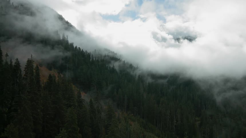 Clouds cover the mountains in valley