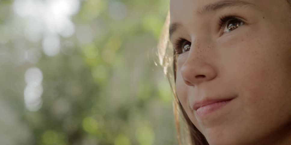 Close up profile of a young girl smiling