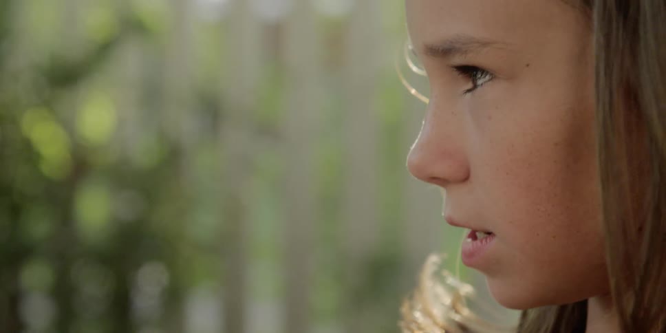 A young girl looks around her surroundings
