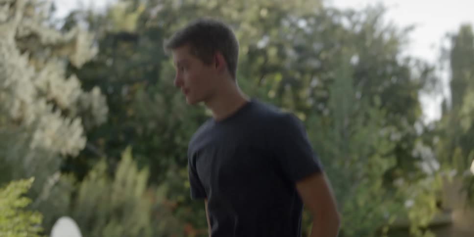 A male teenager jumps on a trampoline