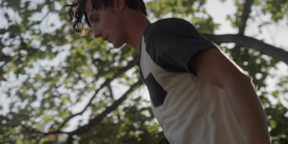 A man jumps on a trampoline outside