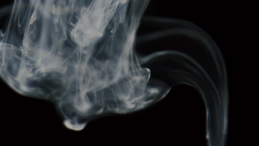 Abstract footage of a white substance sinking in to a liquid