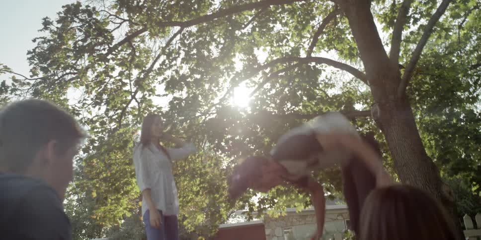 Children are jumping on a trampoline in the yard