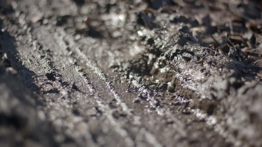 Close up footage of tire tracks in mud