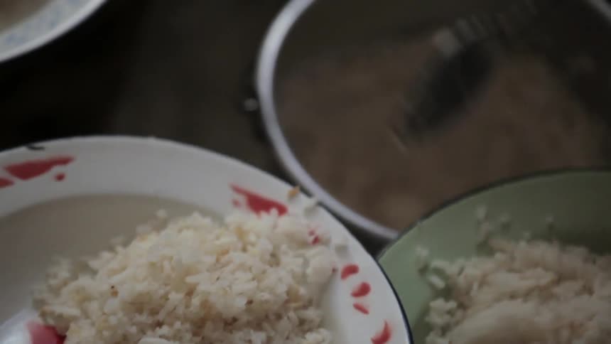 Rice is spooned into bowls