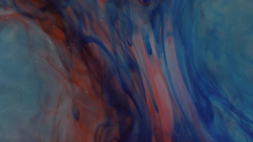 Red and blue smoke swirling in slow motion