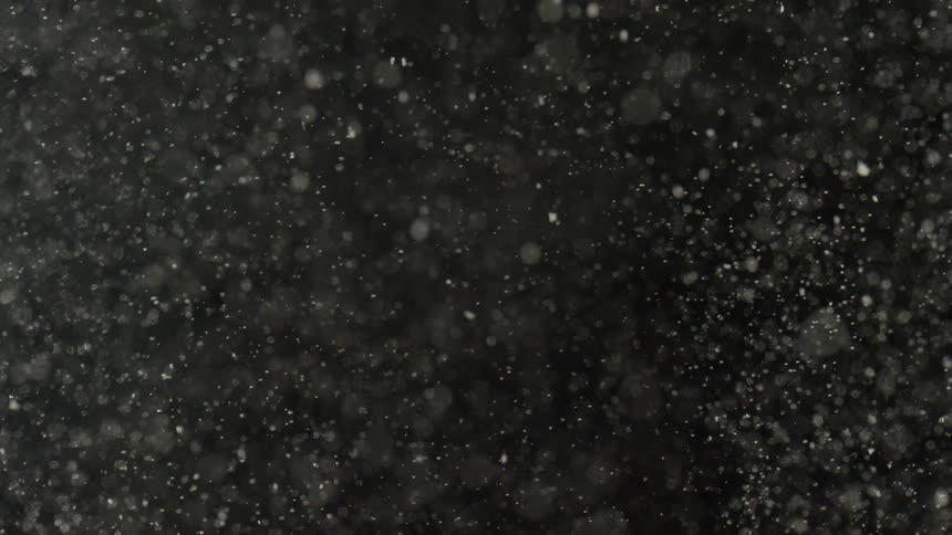 Dust particles fly in a dark background