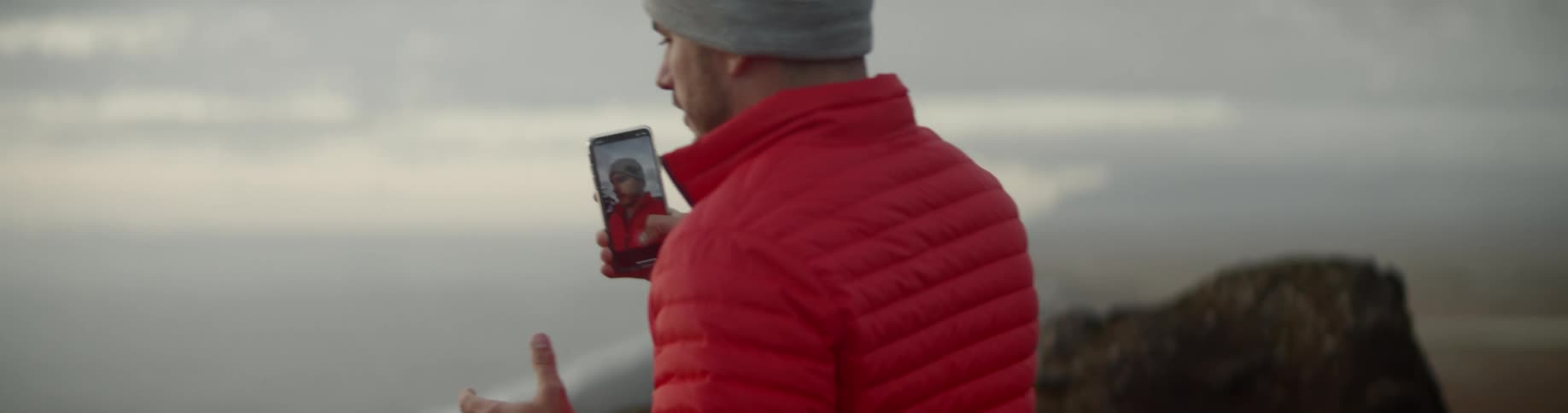 A man makes a selfie video on his phone