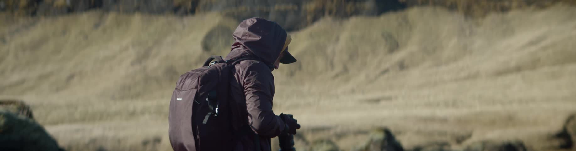 A hiker taking photographs of a ravine