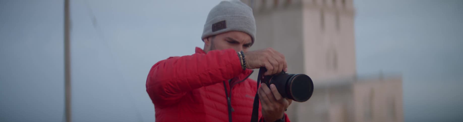 A young white man takes pictures with his camera
