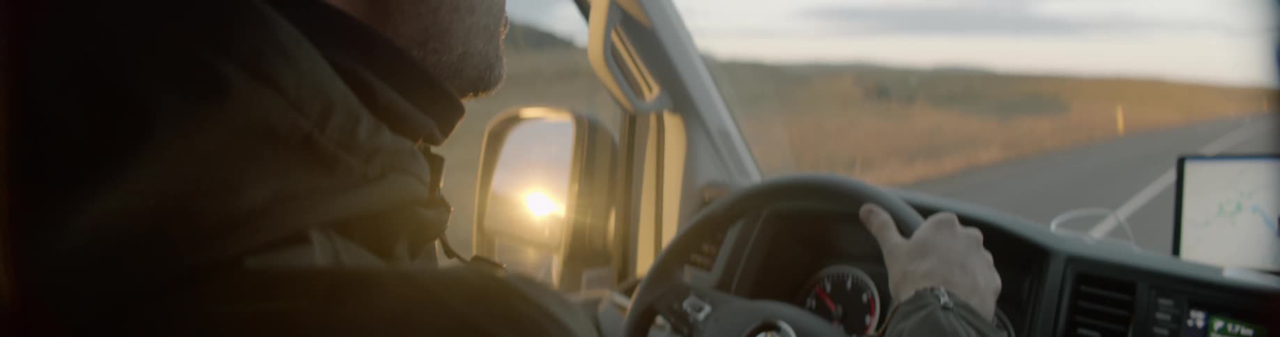 A man is driving a truck on the highway