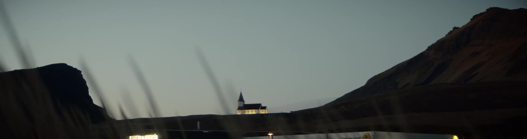A house is on a hill in the distance