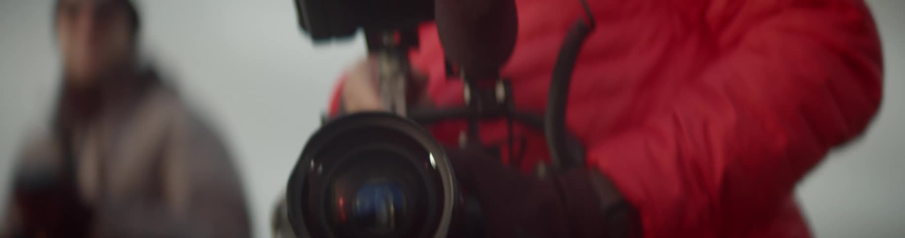 A man holds his camera and turns around