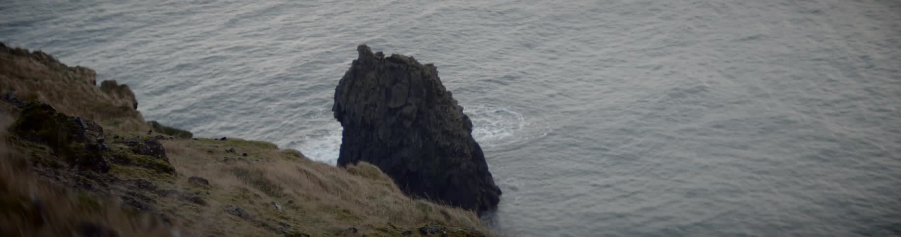 A large rock sits in the water