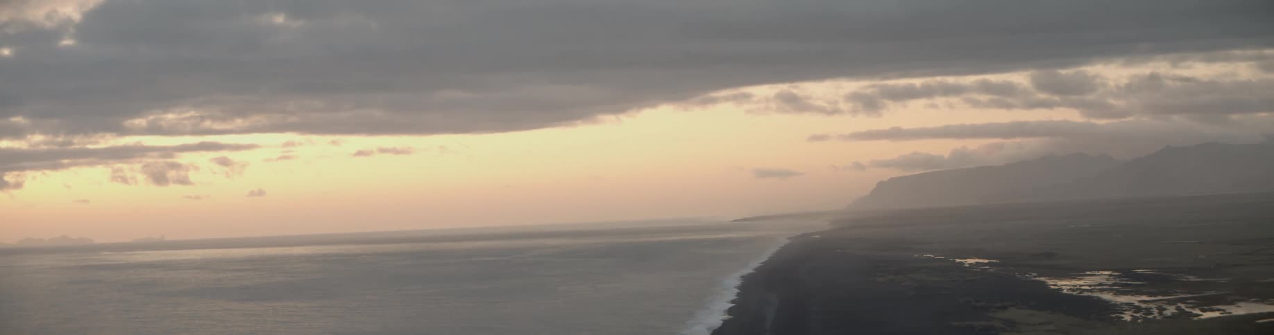 From high above a long shoreline can be seen at the ocean edge