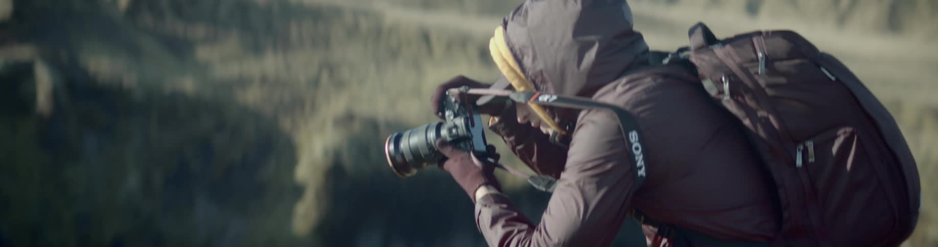 A photographer taking a photograph on a cliff in the badlands