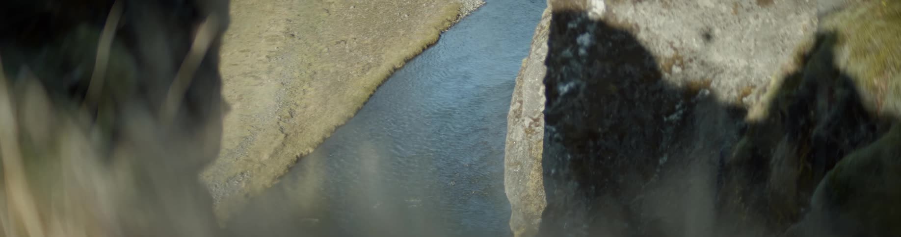 The stream is off the side of the tall cliff