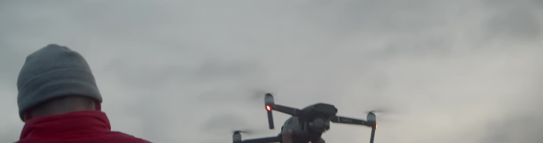 A person catches a drone as it lands in his hand
