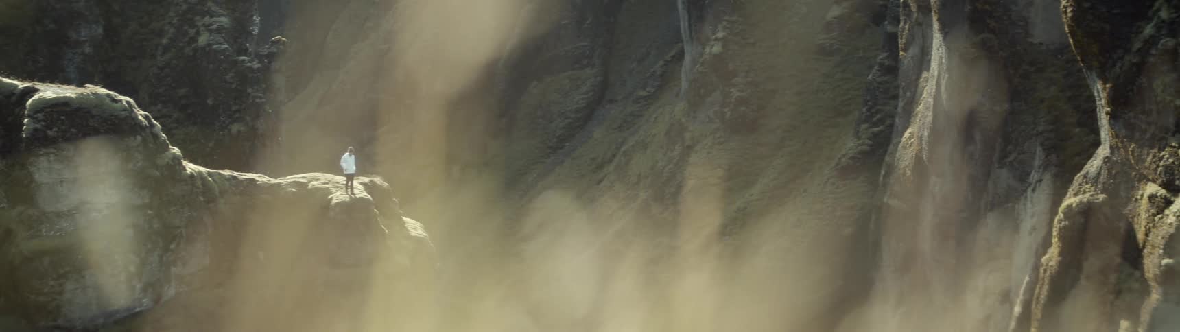 A person runs towards the edge of a cliff