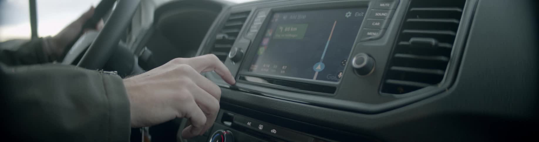 While driving a vehicle the driver presses button on the touch screen control panel in the dashboard
