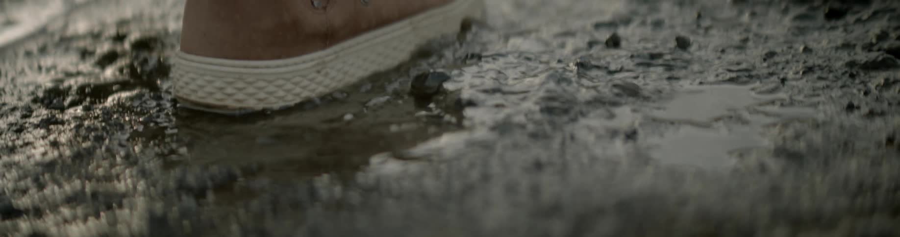 A person is walking in the mud