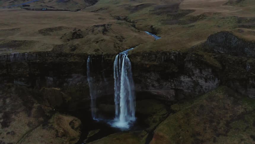 A waterfall cascades over a cliff