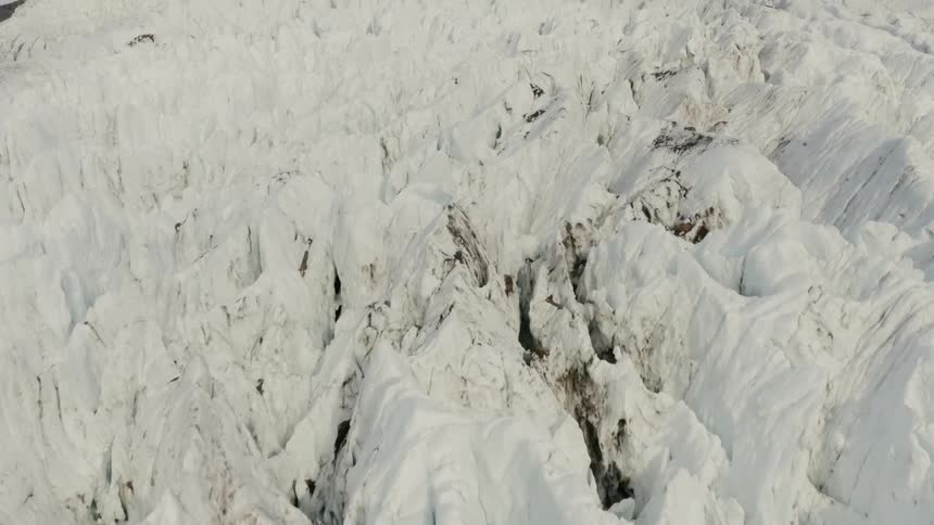 Ice and snow cover steep peaks of mountain range