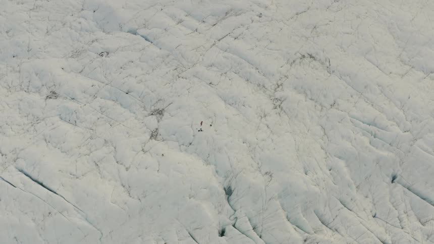 Cracks form in a thick layer of snow covering the ground