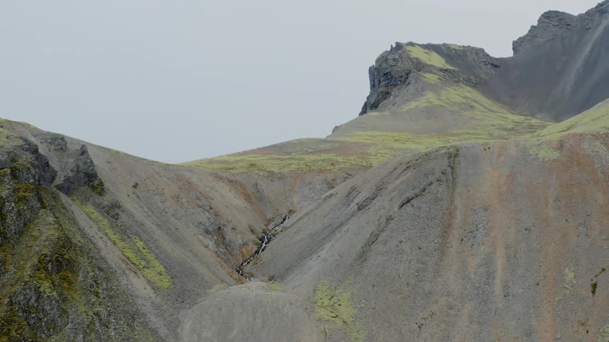 Grass covered slopes of mountain range