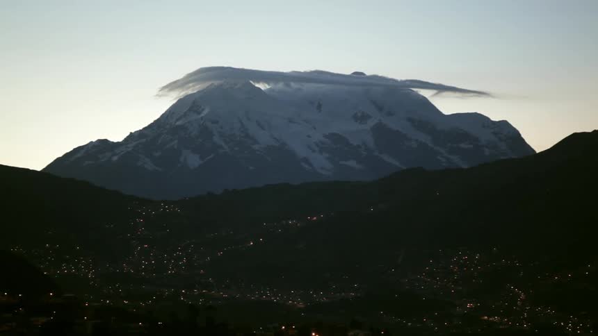 View of a snow covered mountain with clouds on the top