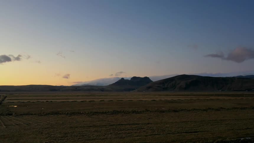 Puddles form on dirt roads that run through flat plains