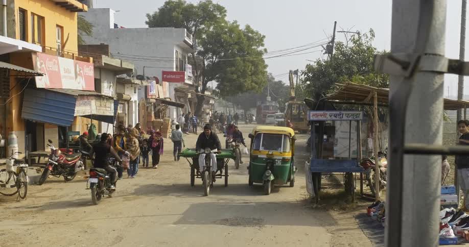 India market area busy with people and their daily commute on bicycles and rickshaws