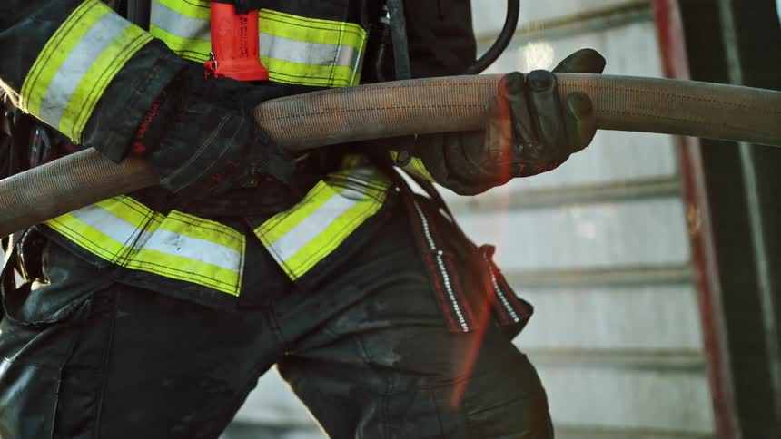 A firefighter holds a water hose
