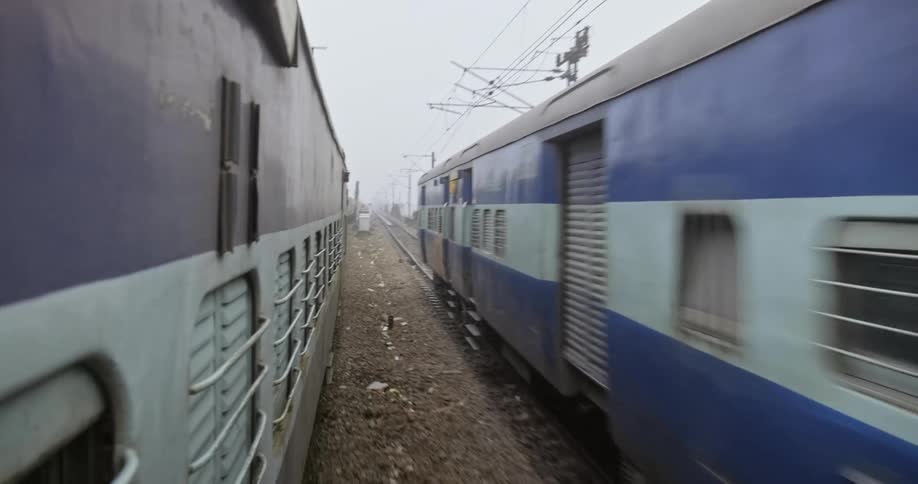 Two trains pass each other on a railway in India