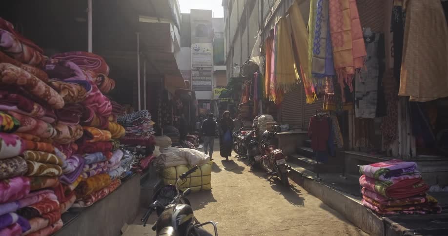 People walk the street of an India fabric market
