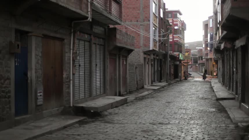 A cart is pulled down a city alley